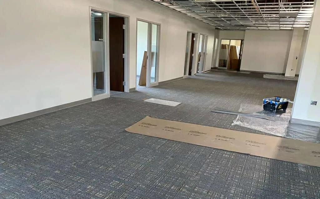 Blue Bell PA commercial painting – interior space with carpet, walls and exposed ceiling by Oasis Painting & Drywall.