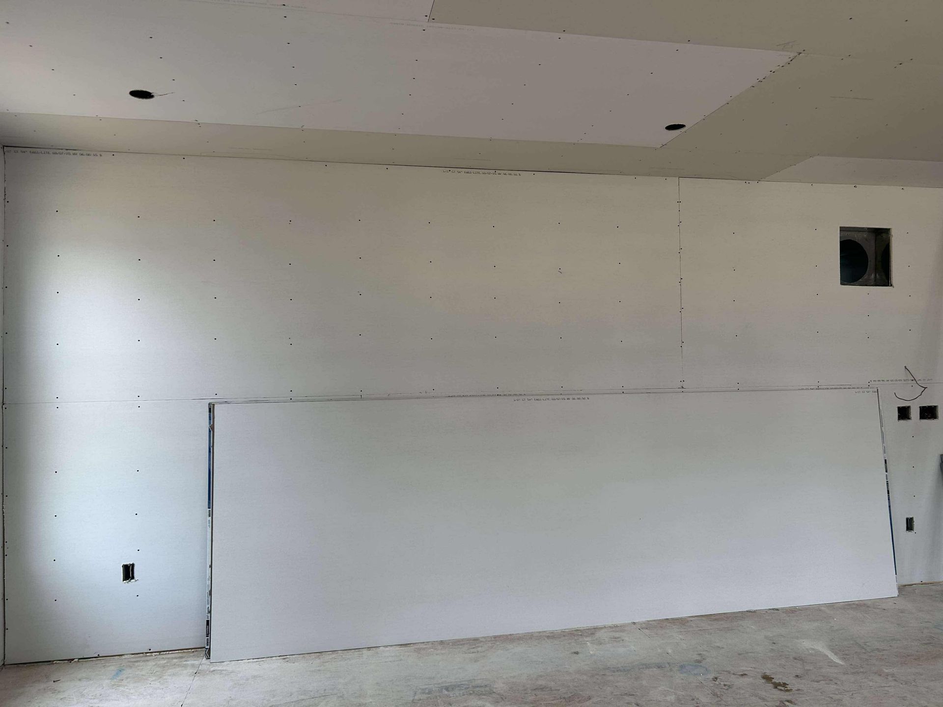 A room with a large white wall and a ceiling.