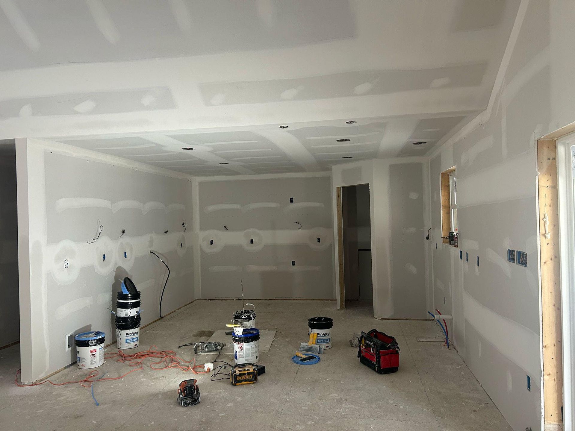 A room that is being remodeled with drywall on the walls.