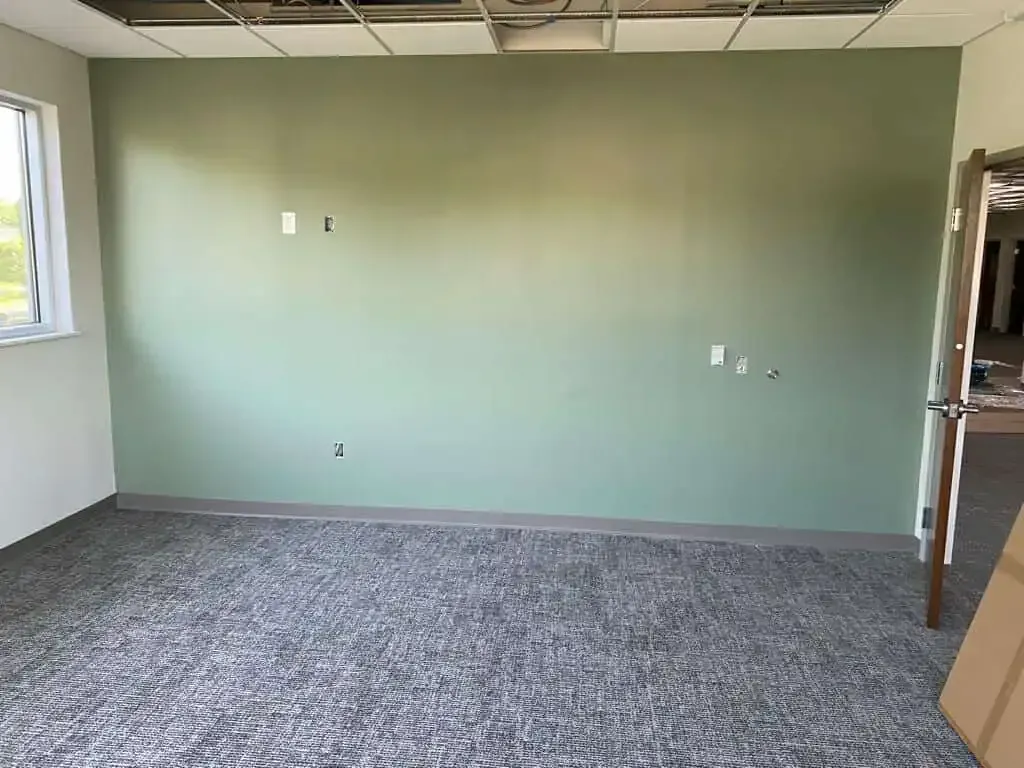 North Wales office painting – green accent wall with white walls by professional painters Oasis Painting & Drywall