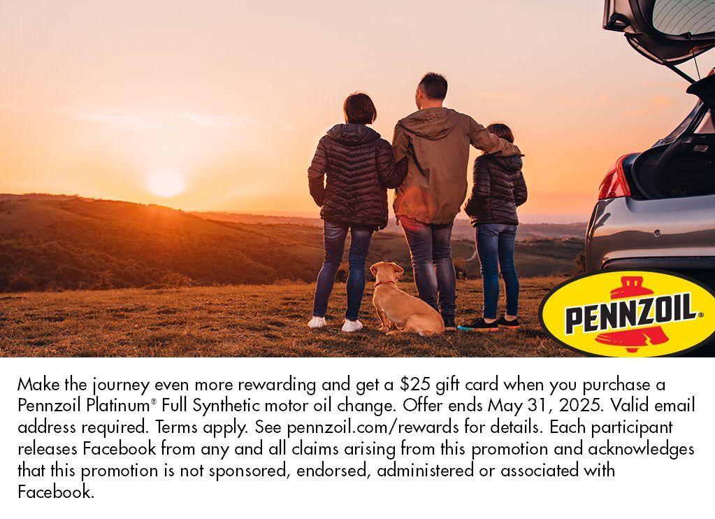 A group of people standing next to a pennzoil car.