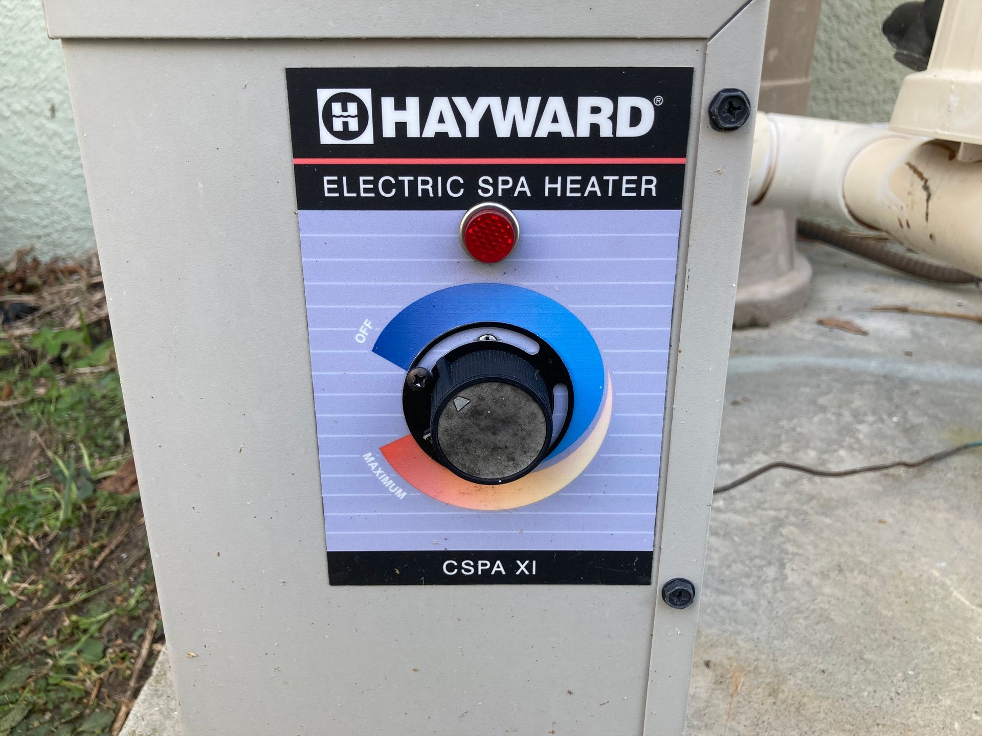 Hayward electric spa heater control panel. Tan box, temperature dial, red light.
