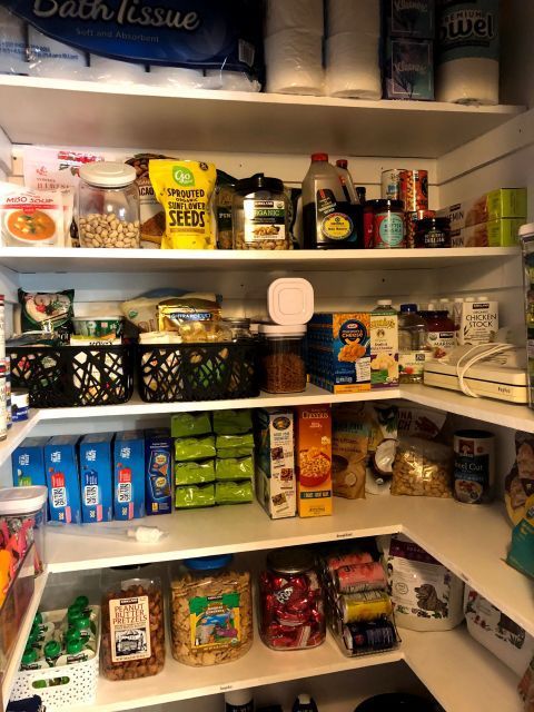 Pantry shelves stocked with various food items including snacks, cereals, and canned goods.