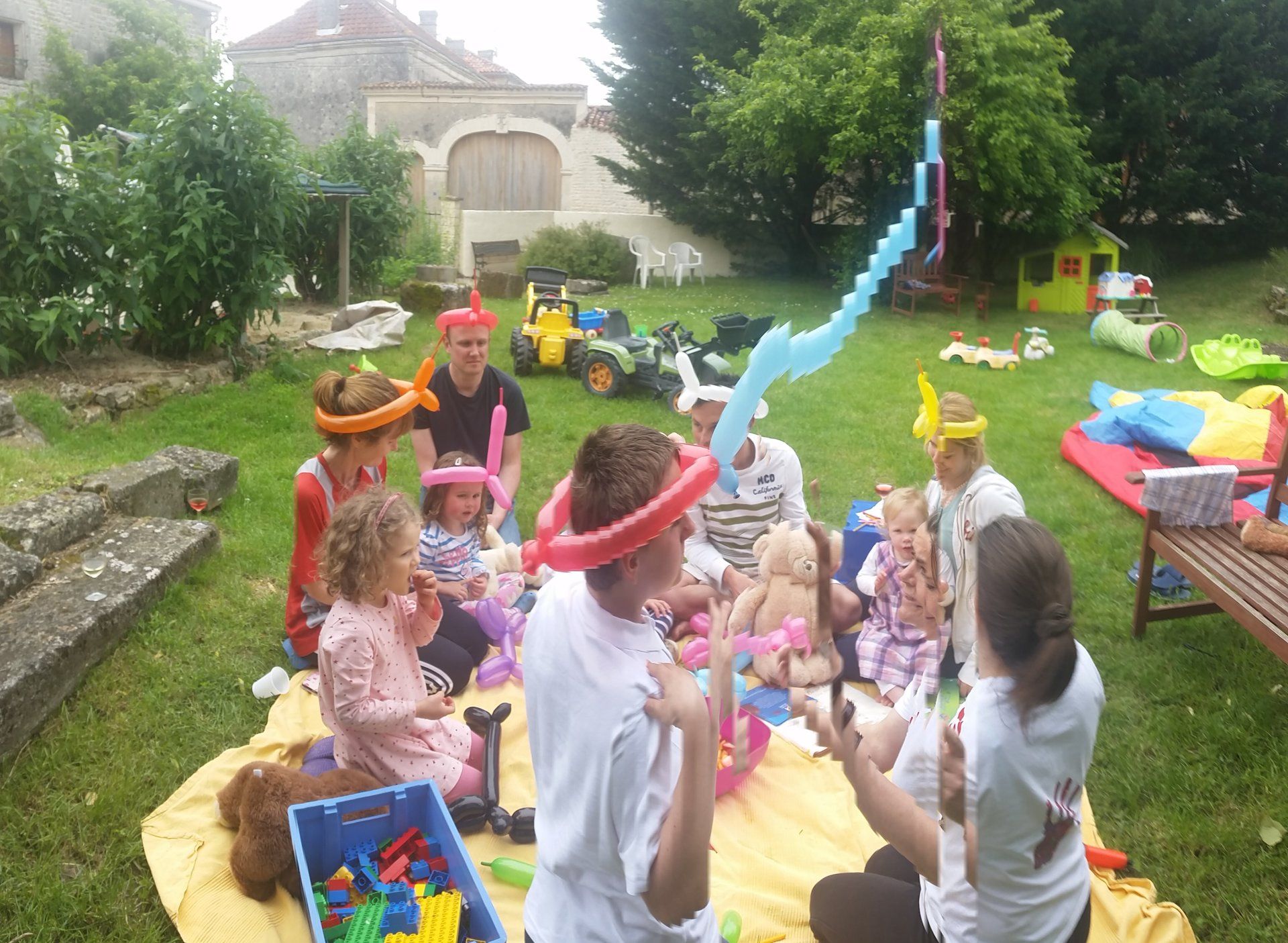 children at a teddy bear picnic with balloon hats