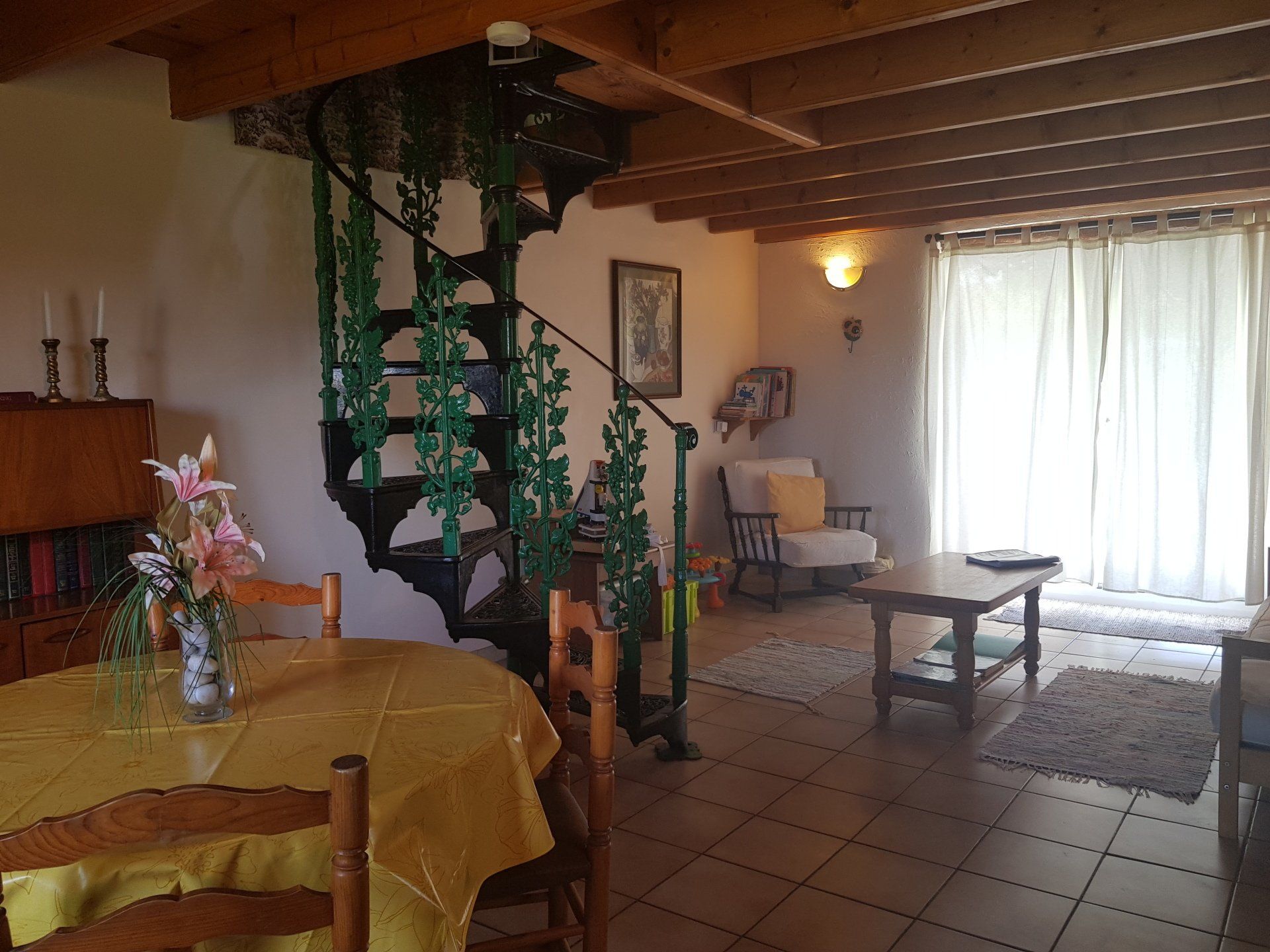 sitting room with green and black caste iron spiral staircase