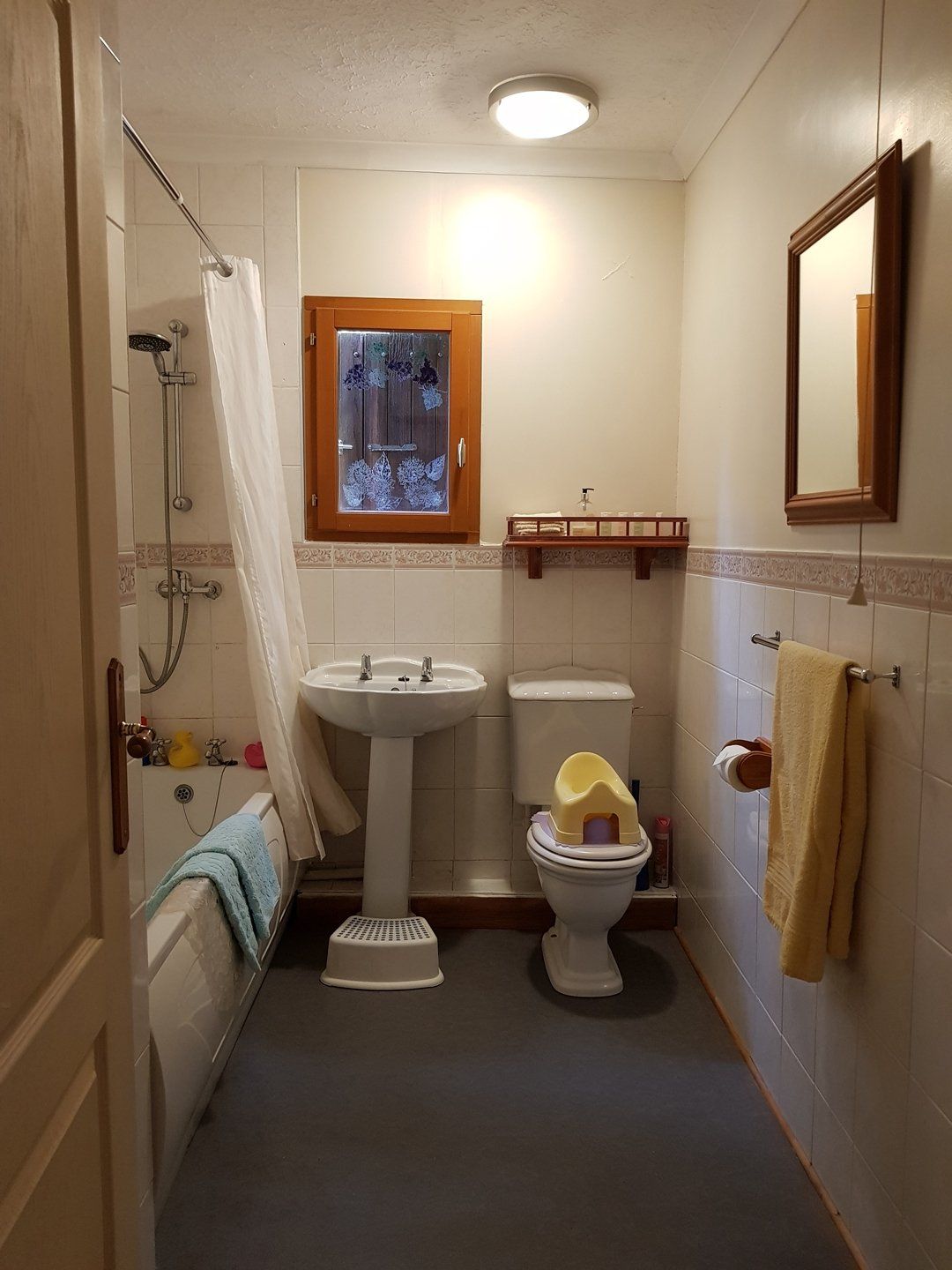 white bathroom suite with grey flooring
