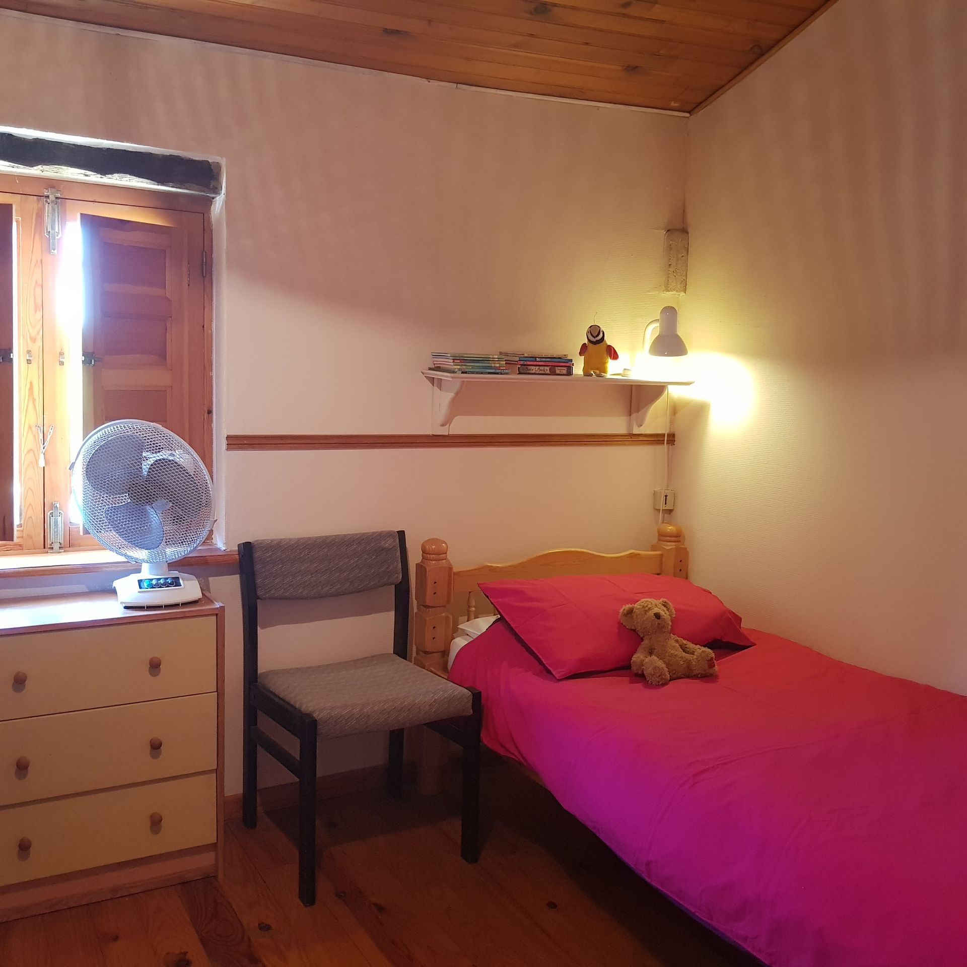 childrens bed with bright pink bedspread