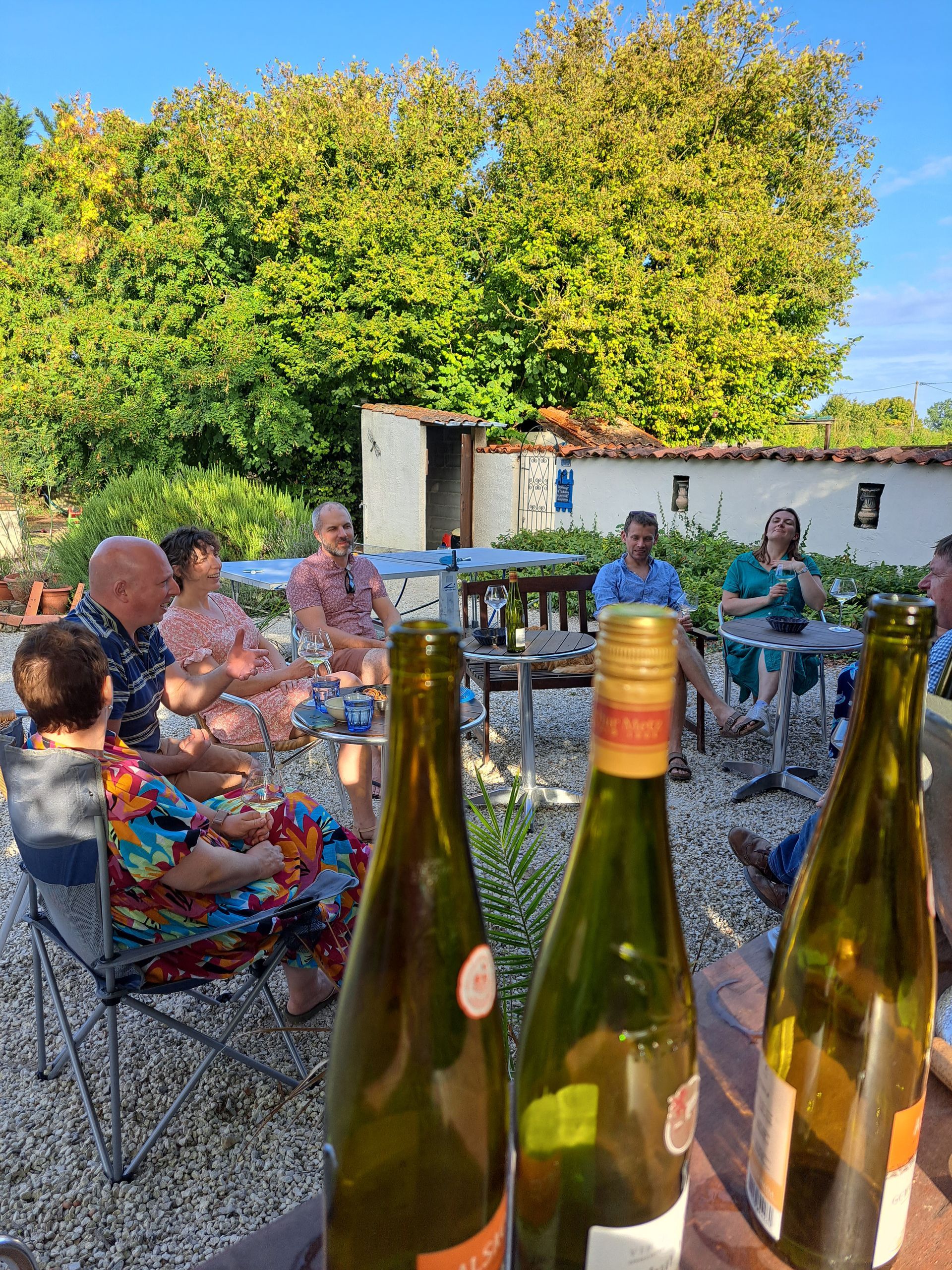 several couples sat outside drinking wine