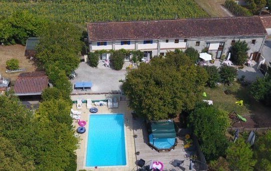 aerial shot of swimming pool and a row of cottages in France