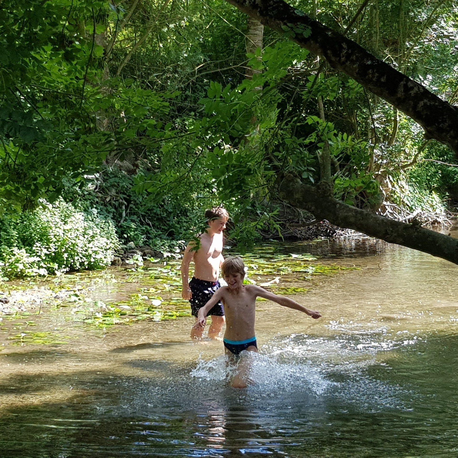 boys paddling in river Boutonne