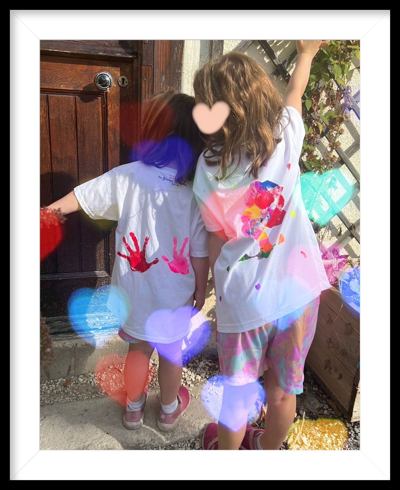 two girls showing off the backs of their handpainted t-shirts