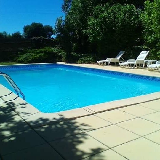 swimming pool 10m by 5m surrounded by sandstone coloured paving slabs