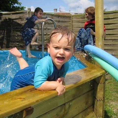 toddler splashing in a small pool