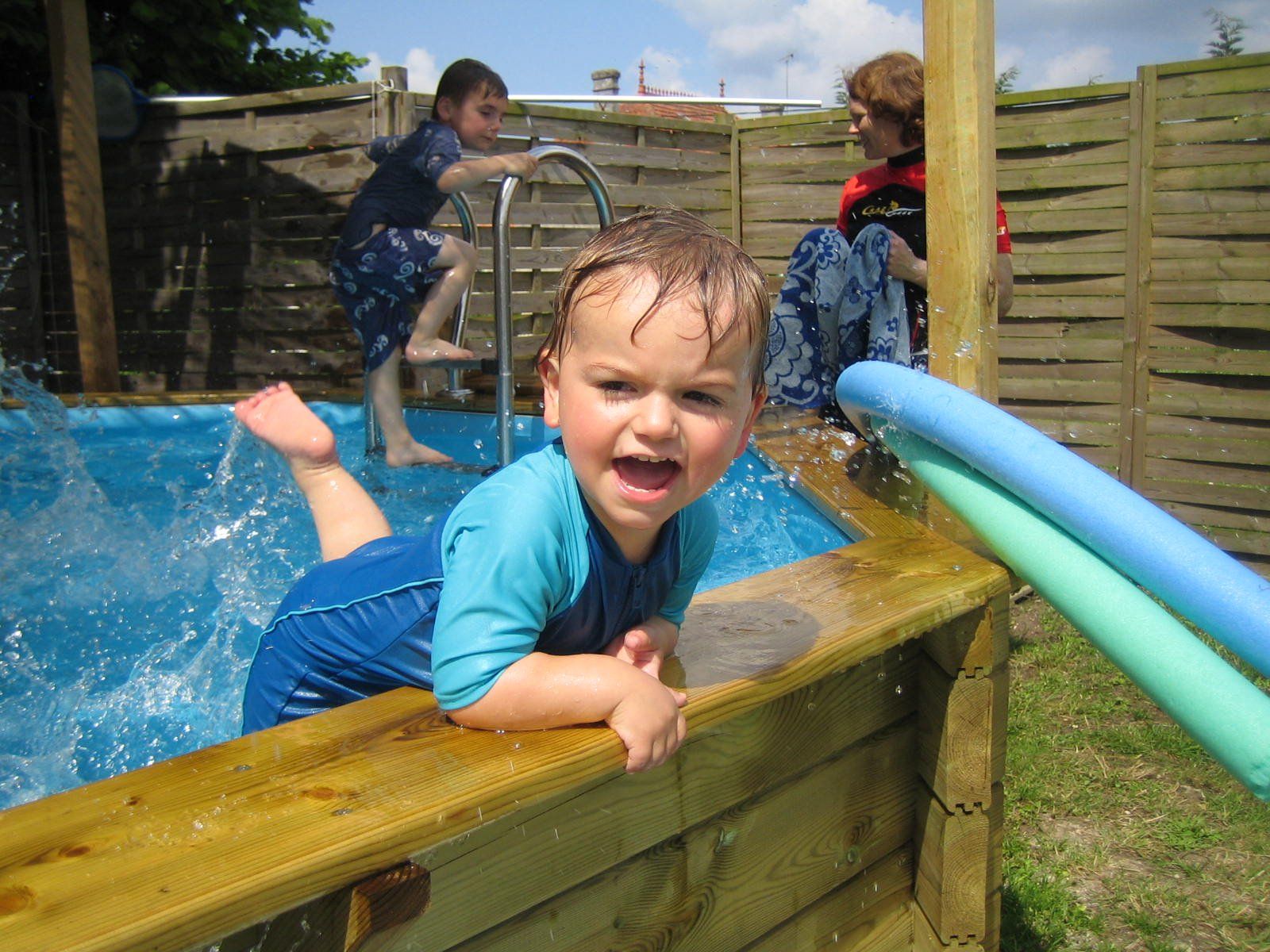 a toddler splashing in the heated toddler pool