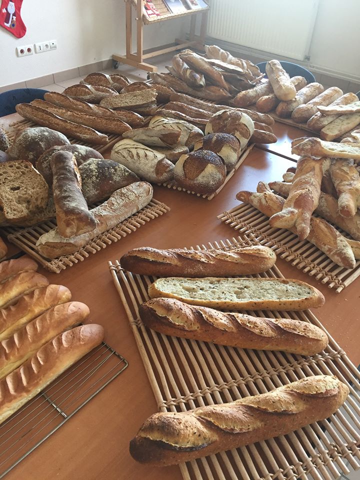 a table covered in different french breads