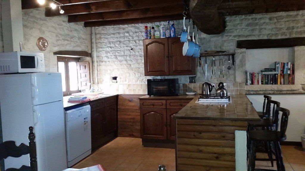 keuken met donkere eiken deuren en bruin betegeld werkblad