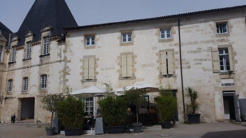 stone building with steep slate roof 