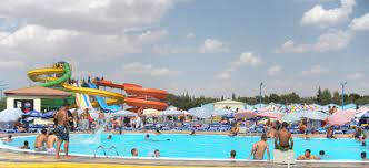 a water park in Angouleme, France, with big colourful slides and lots of people