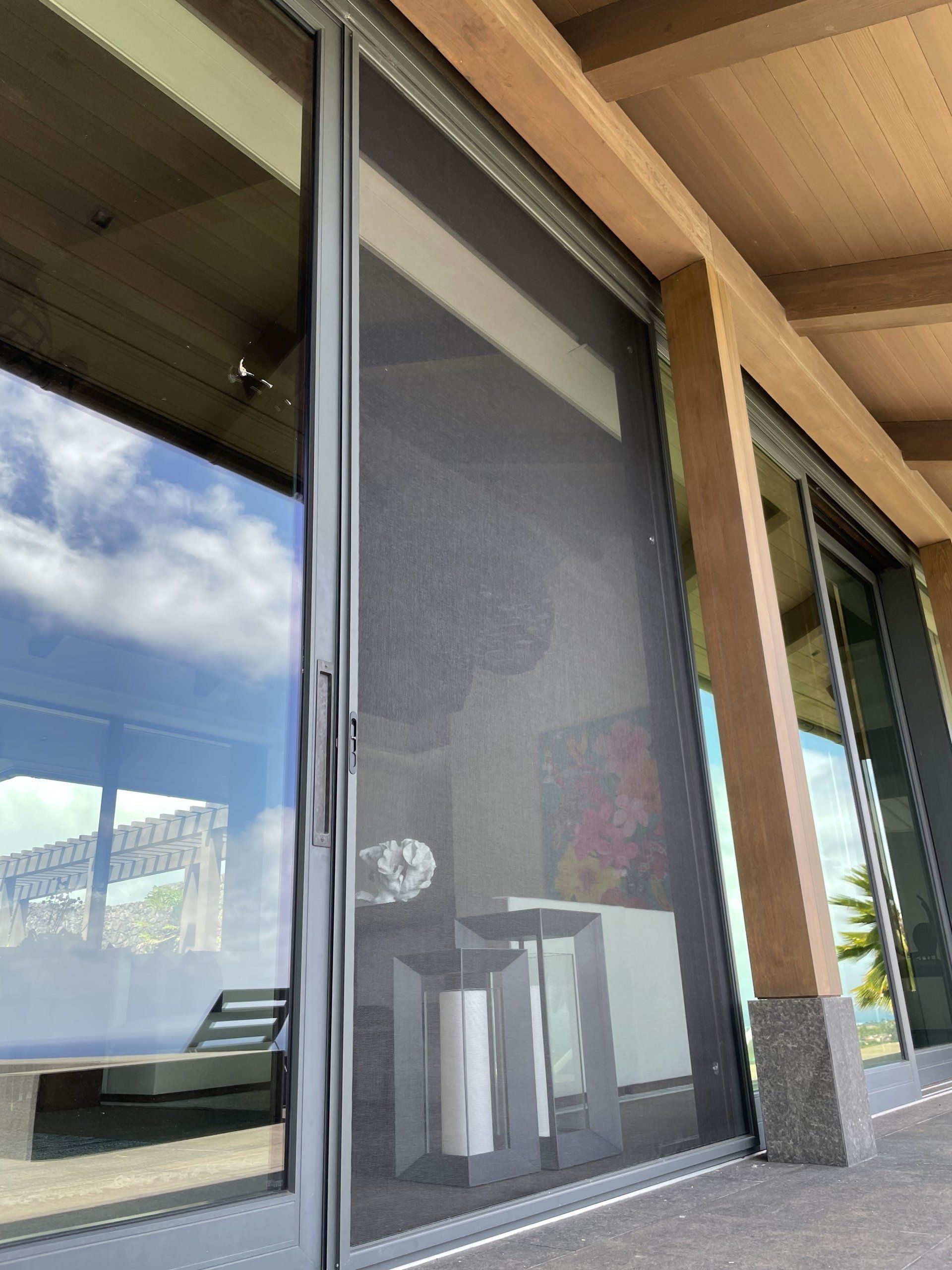 Sliding glass door with retractable screen; outdoor patio setting.