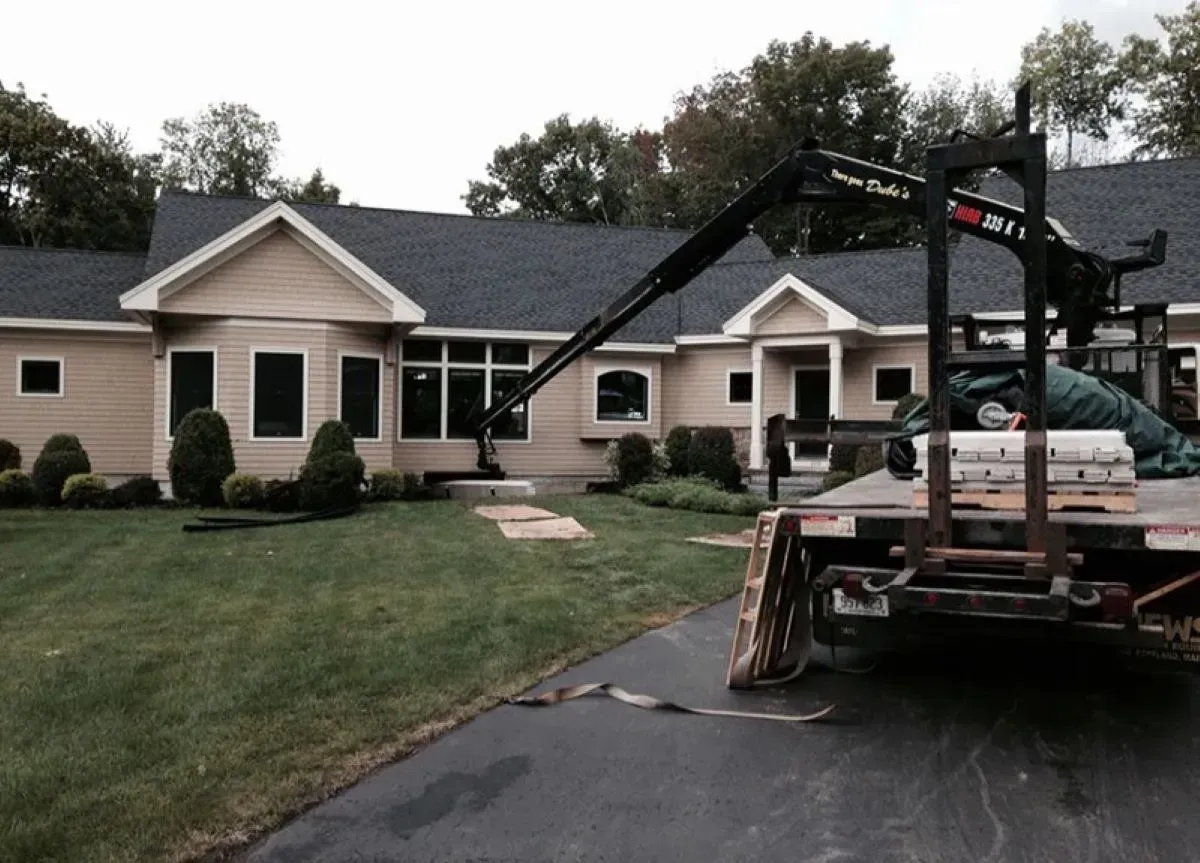 A tow truck is parked in front of a house