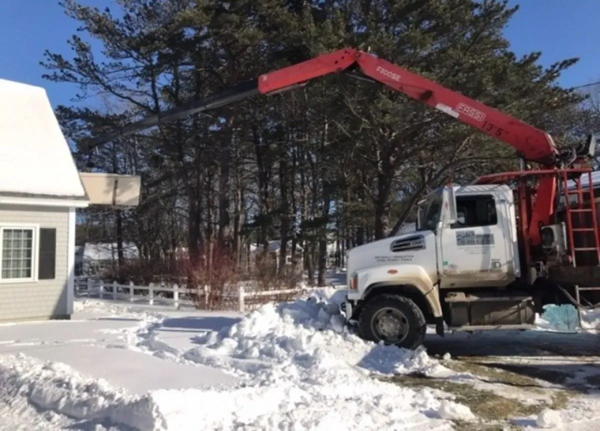 A white truck with a red crane attached to it