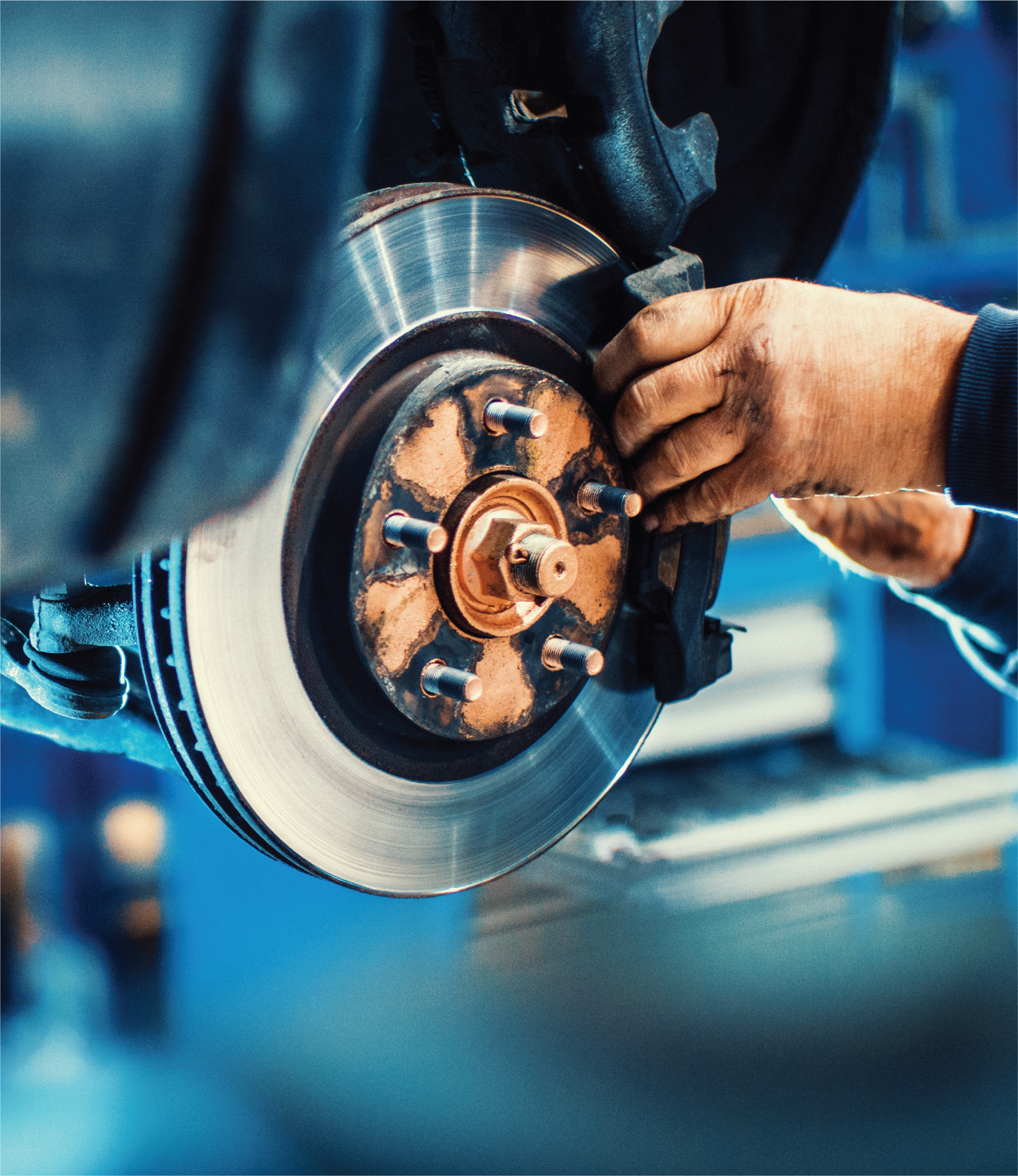 A person is working on a brake disc on a car.