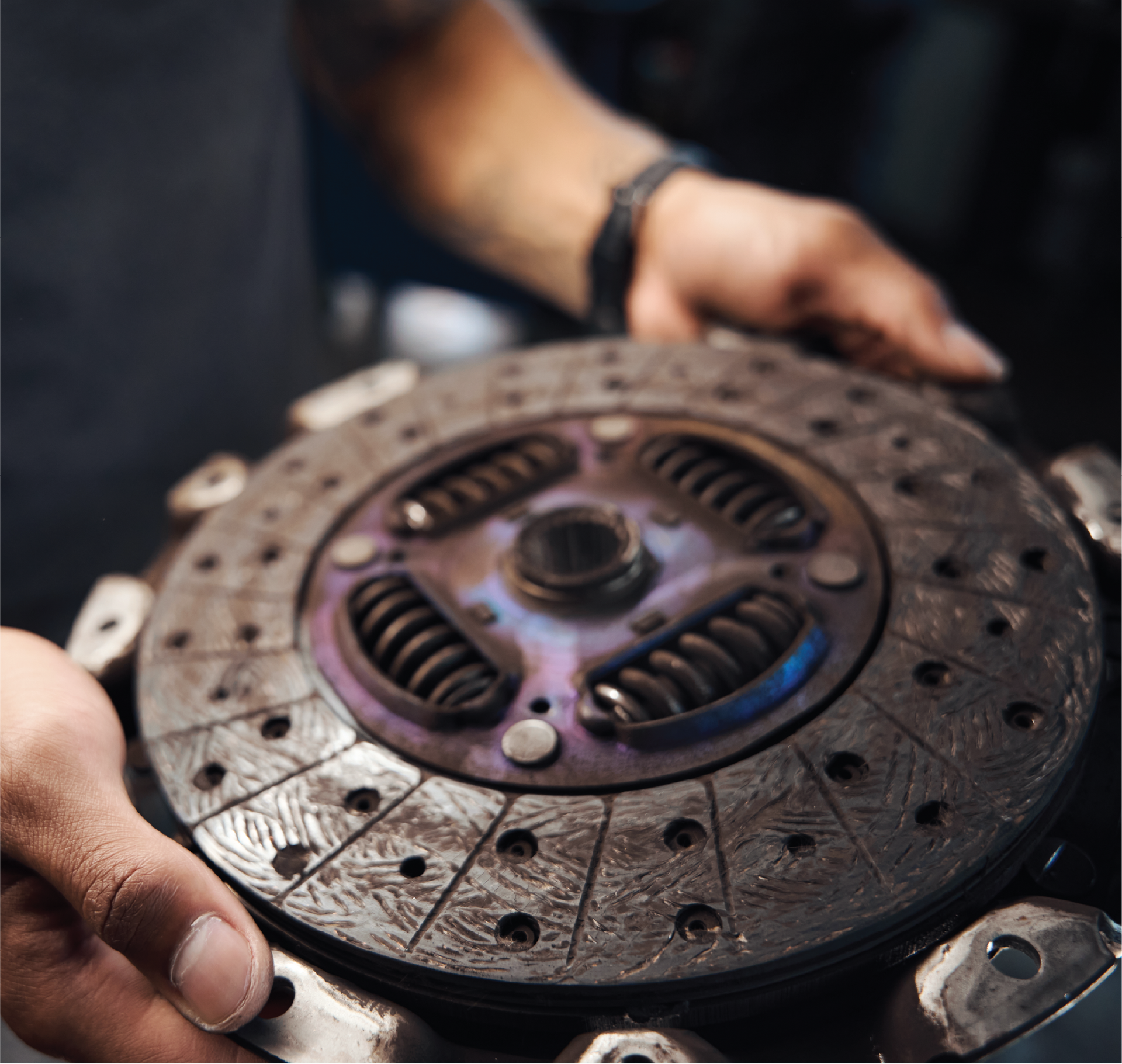 A close up of a person holding a clutch disc