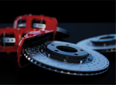 A close up of a brake disc on a black surface