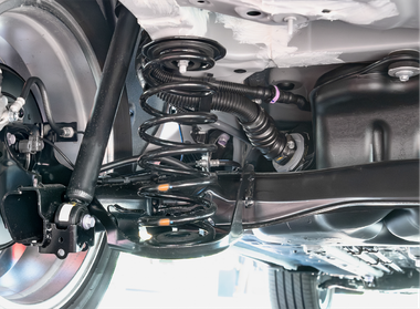 A close up of the rear suspension of a car.