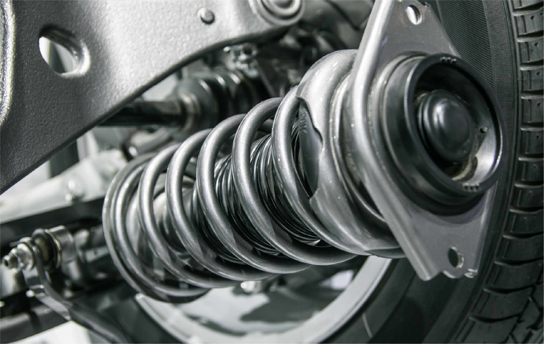 A close up of a shock absorber on a car.