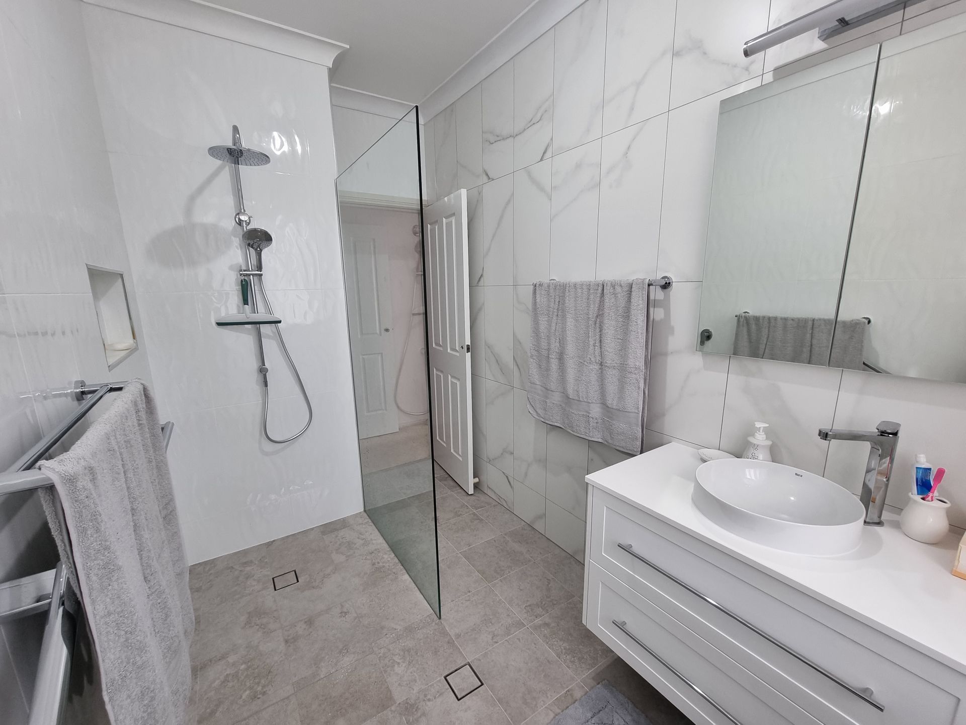 A Bathroom with A Sink, Mirror and Walk in Shower — L.L Projects in Gloucester, NSW