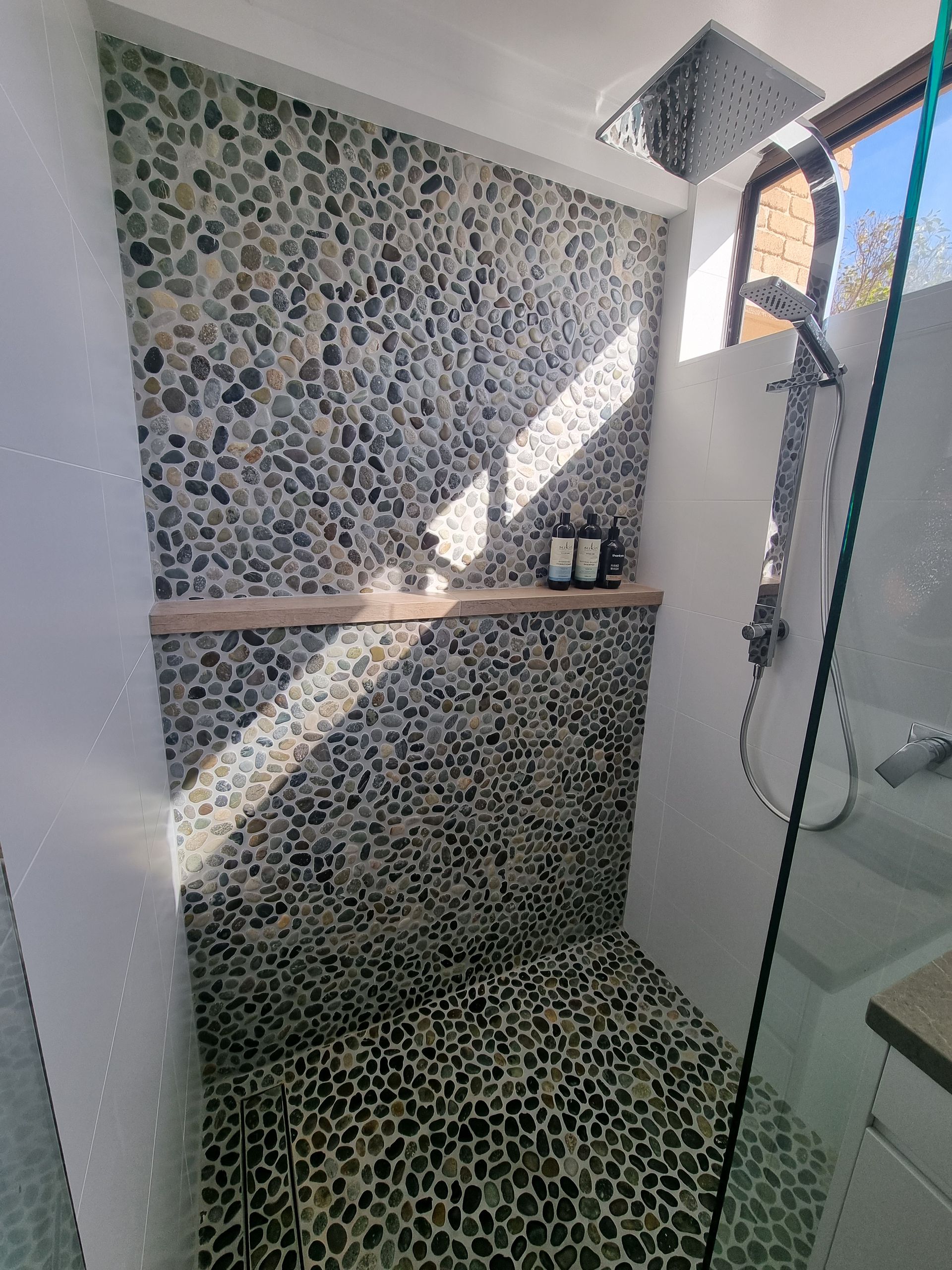 Fresh Shower Behind Wet Glass Window With Water Drops Splashing — L.L Projects in Smiths Lake, NSW