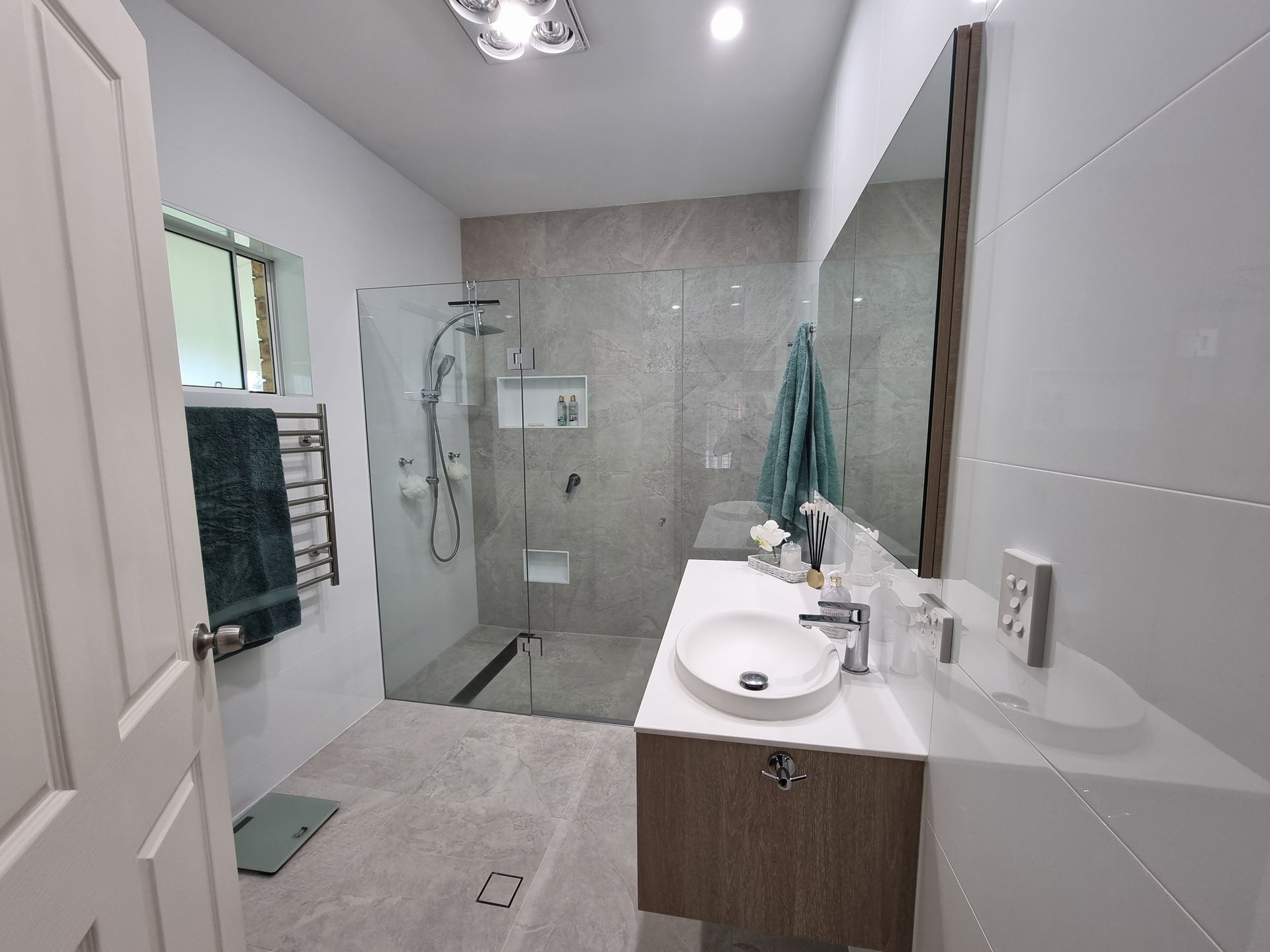 Bathroom With Grey and White Wall Tiles and Wooden Worktop — L.L Projects in Gloucester, NSW