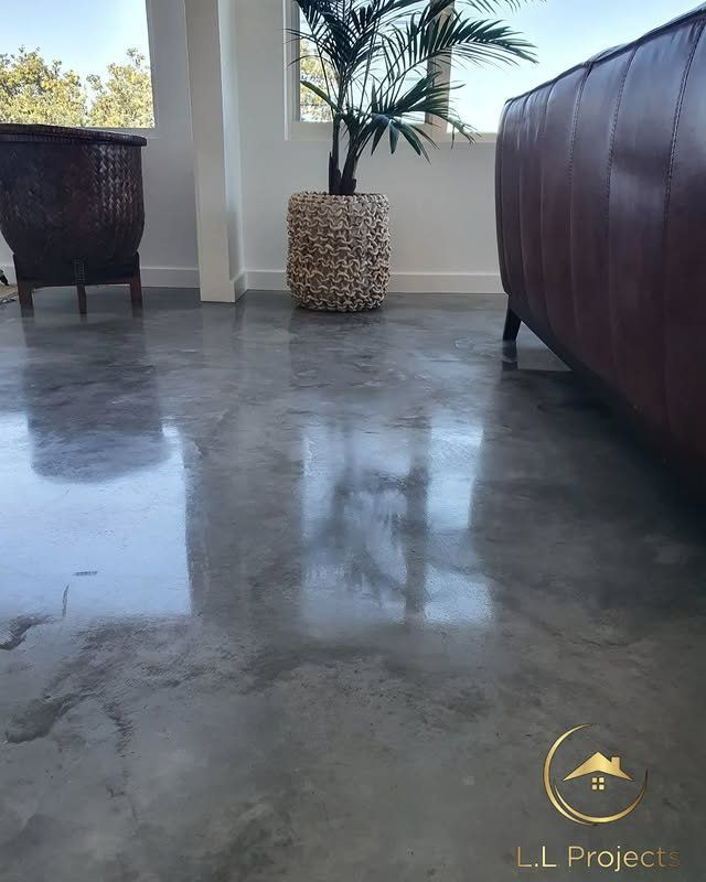 A Living Room with A Couch and A Potted Plant on The Floor — L.L Projects in Gloucester, NSW