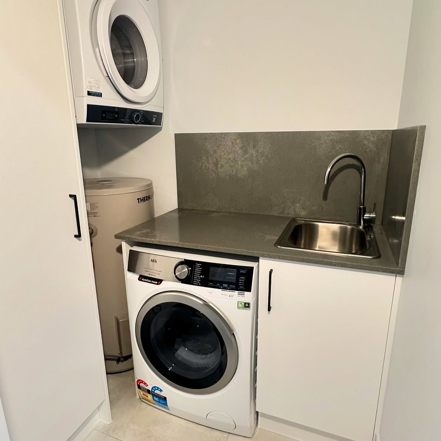 A Laundry Room with A Washer and Dryer and A Sink — L.L Projects in Gloucester, NSW