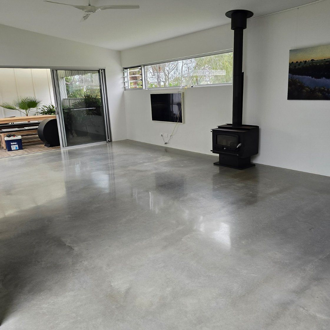 A Living Room with A Fireplace and A Painting on The Wall — L.L Projects in Tuncurry, NSW