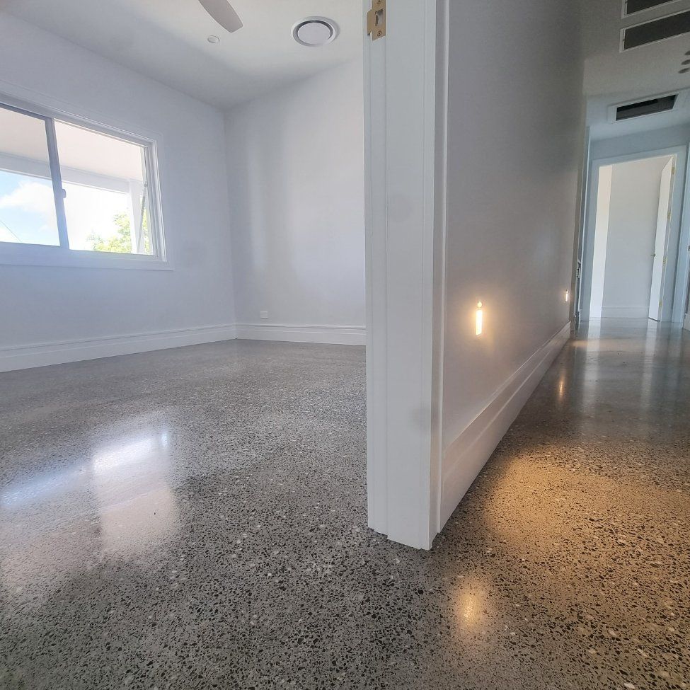 An Empty Room with A Concrete Floor and White Walls — L.L Projects in Taree, NSW