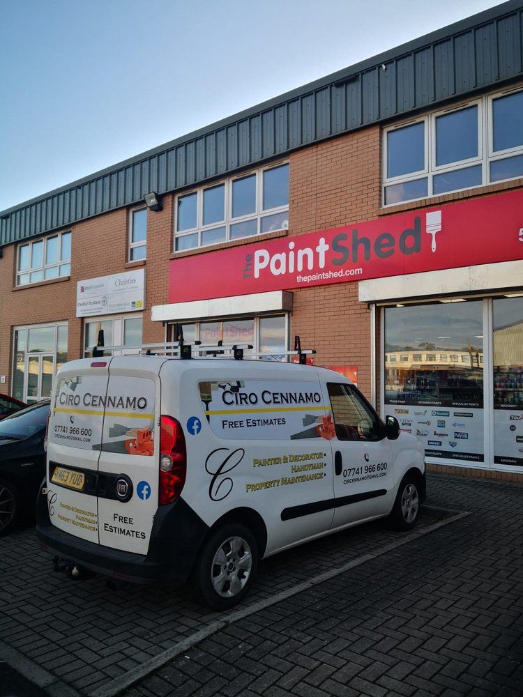 white van by red building