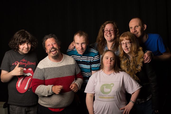 7 actors with learning disabilities standing together and smiling