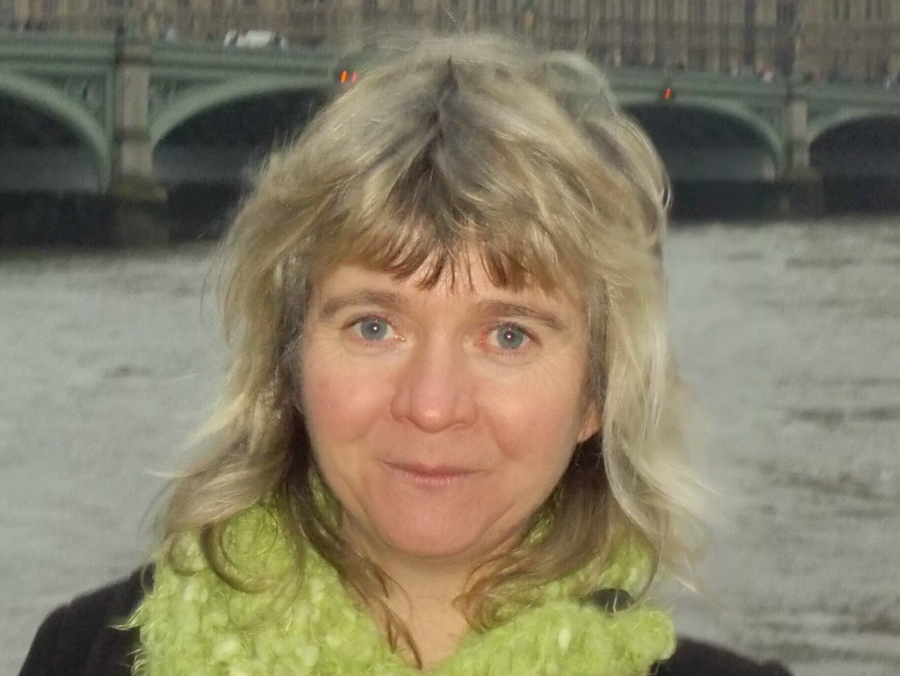 Head and shoulders photo of Alison, medium length hair, and wearing a green scarf.