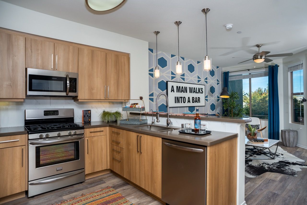 Open-concept kitchen with wood cabinets, stainless steel appliances, and an island.