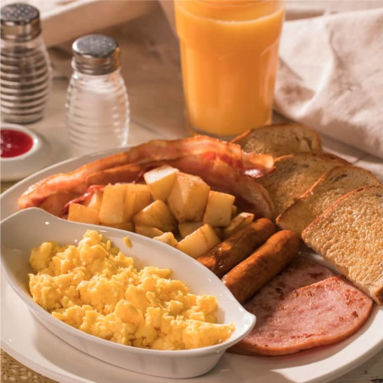 photo of scrambled eggs with hash browns, toast, and sausage