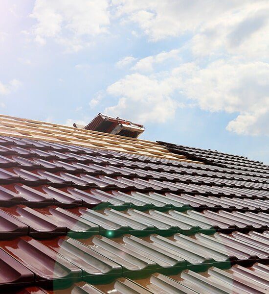 A Roof With A Lot Of Tiles On It And A Blue Sky In The Background — CP Roofing in Old Bar, NSW