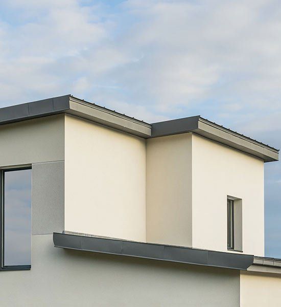 A White House With A Black Roof And A Window — CP Roofing in Harrington, NSW