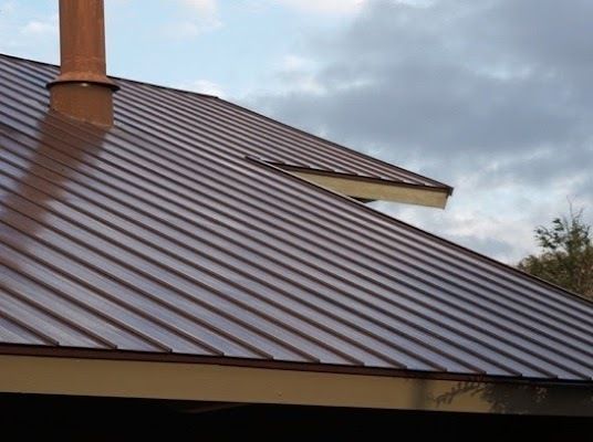 A Brown Metal Roof With A Chimney On Top Of It — CP Roofing in Wingham, NSW