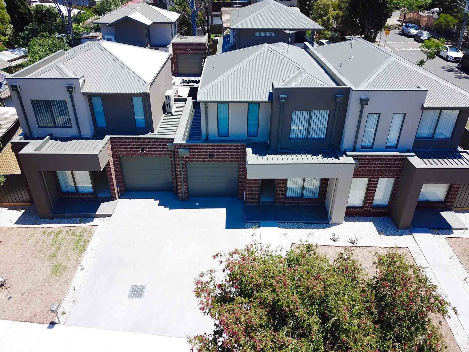 An Aerial View Of A Row Of Houses In A Residential Area — CP Roofing in Forster, NSW