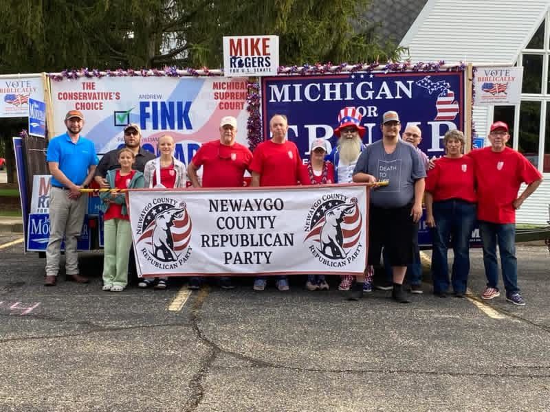 Newaygo County Republican Party float with supporters, banners, and signage: 