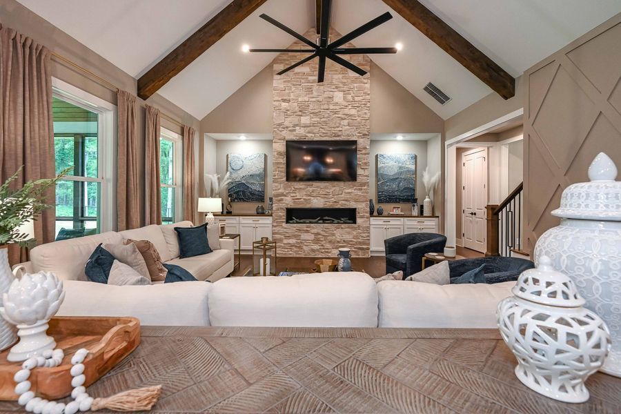 Living room with stone fireplace, large sectional sofa, and decorative accents.