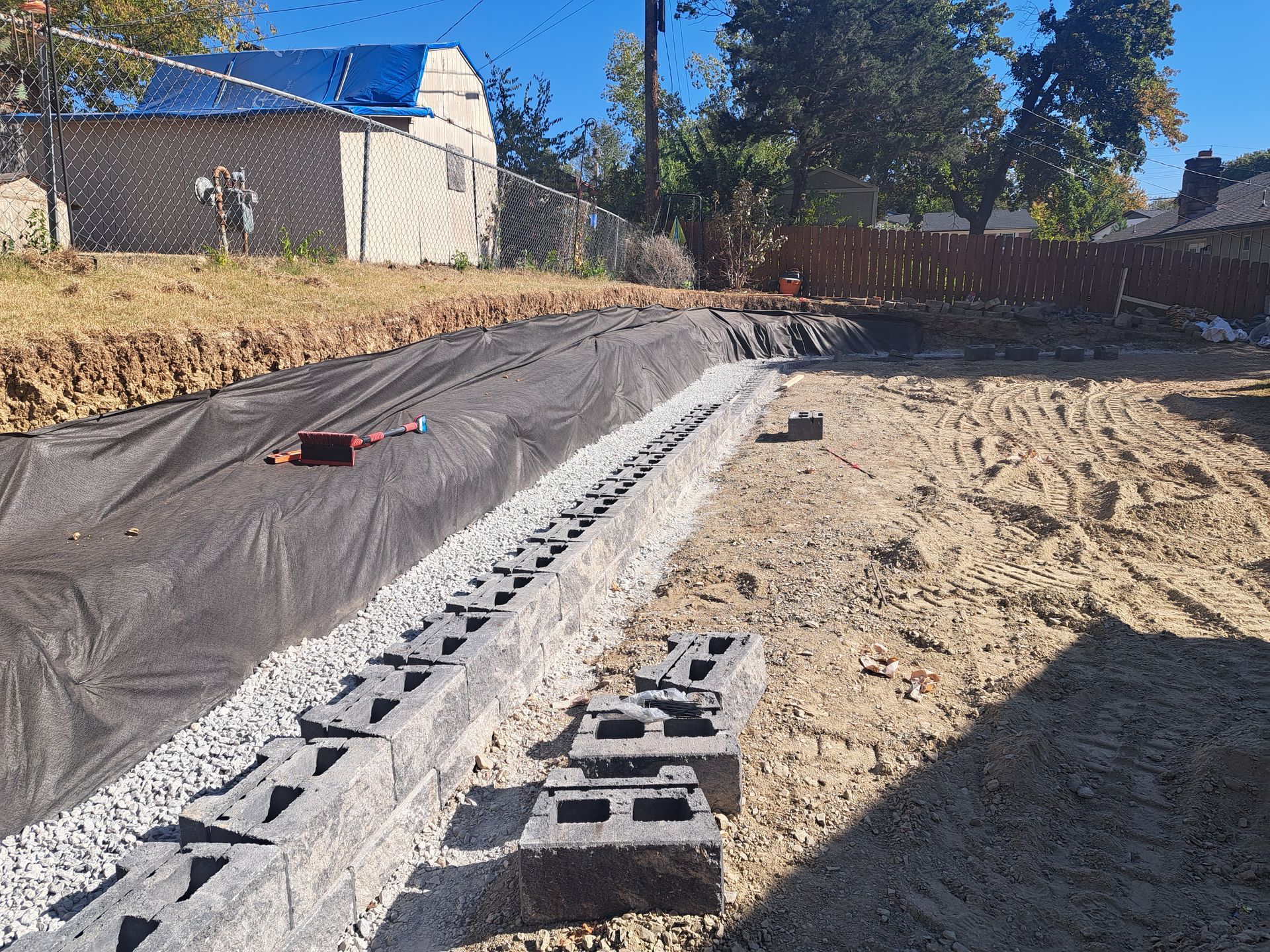 A drainage system is being built in a backyard.