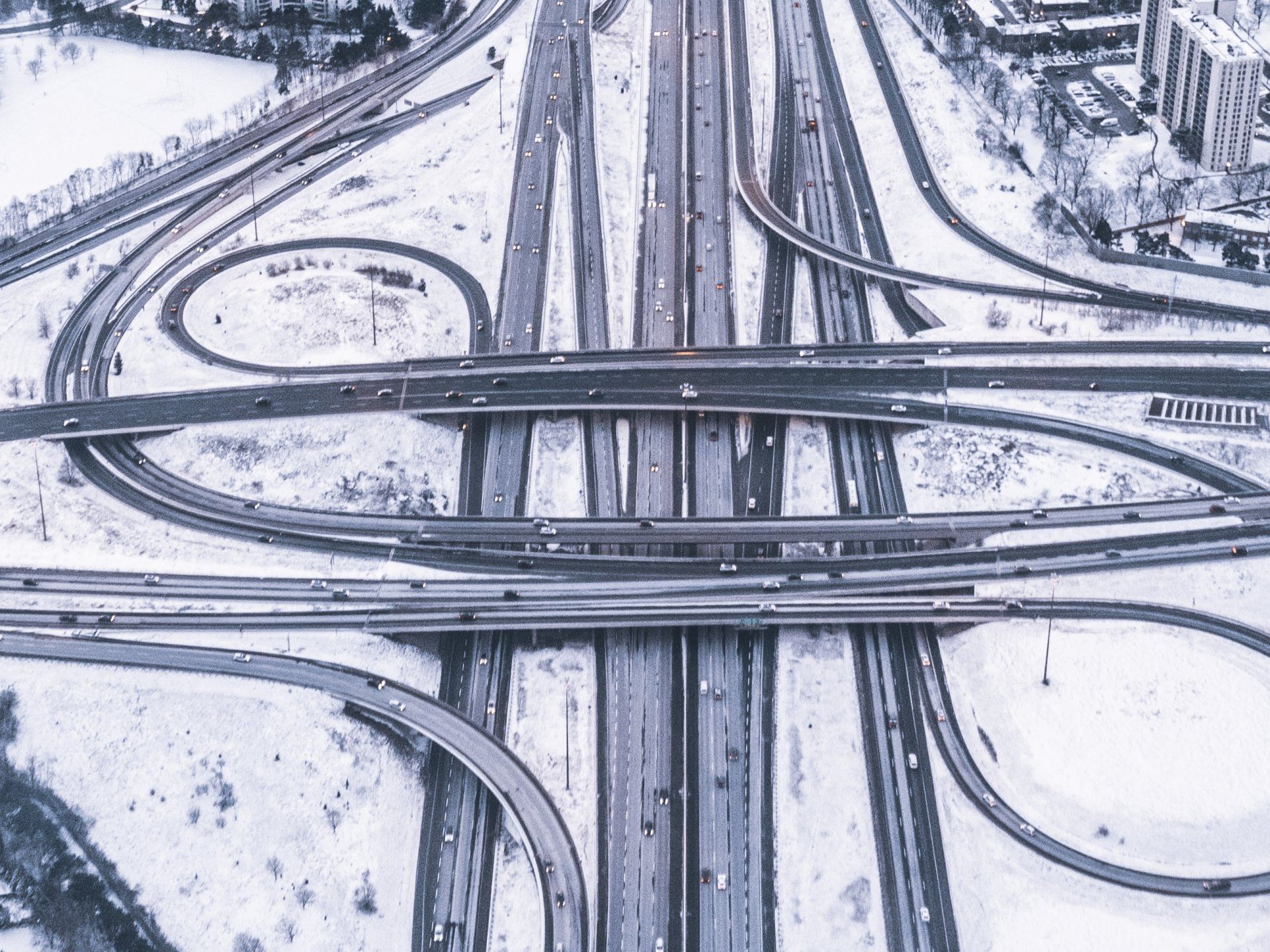 An aerial view of a highway intersection in the snow.